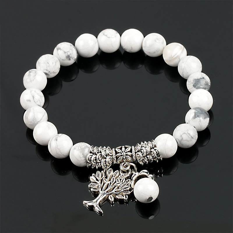 Tree of Life white turquoise bracelet with white beads and gray marbling, silver-toned decorative spacers and tree of life pendant.