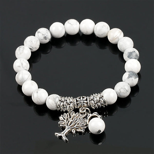 Tree of Life white turquoise bracelet with white beads and gray marbling, silver-toned decorative spacers and tree of life pendant.