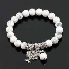 Tree of Life white turquoise bracelet with white beads and gray marbling, silver-toned decorative spacers and tree of life pendant.