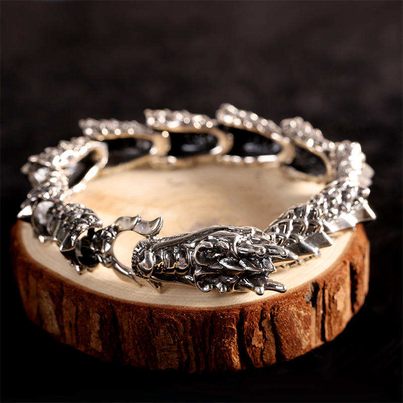 Sterling Silver Dragon Bangle - Dragon head clasp on natural wood prop, bold statement jewelry