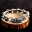 Sterling Silver Dragon Bangle - Dragon head clasp on natural wood prop, bold statement jewelry