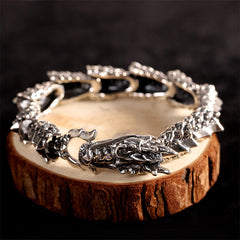 Sterling Silver Dragon Bangle - Dragon head clasp on natural wood prop, bold statement jewelry