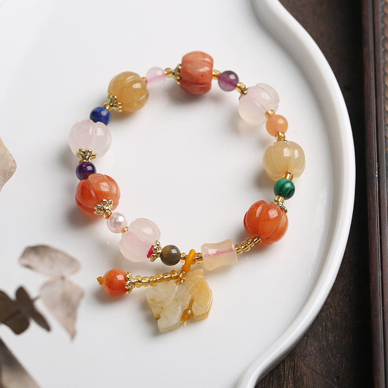 Golden Silk Jade Gourd Bracelet – Colorful jade bracelet with PiXiu on white dish
