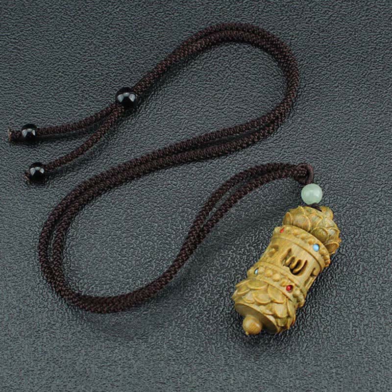 Om Mani Padme Hum Necklace – Carved wooden lotus pendant with openwork, adjustable black bead cord, gray backdrop