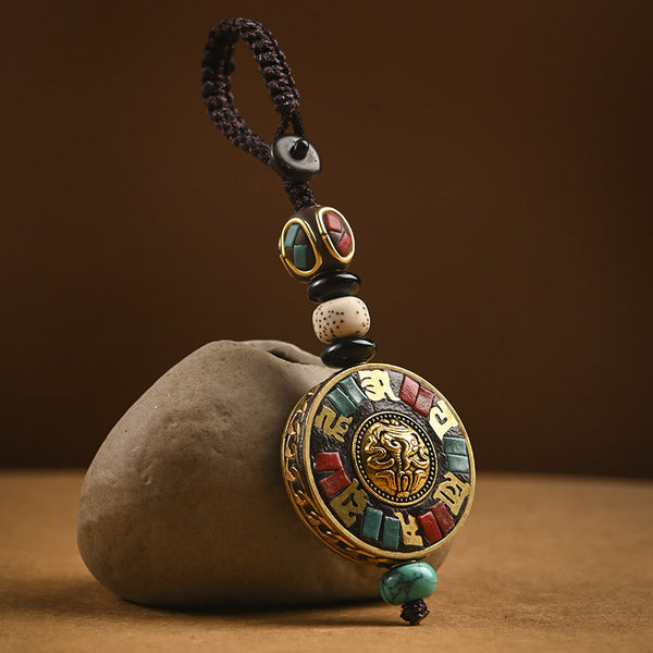 Tibetan Bodhi Seed Peace Key Chain – Gold snow lion medallion with turquoise inlay and Tibetan script, bag charm