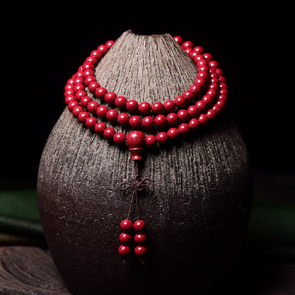 108 Mala Beads Cinnabar Bracelet – Front display on ceramic stand, red mala tassel
