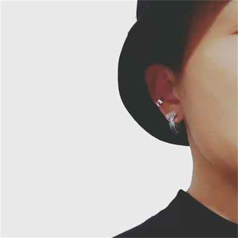 Sterling Silver Dragon Hoop Earrings – worn on ear with black hat, minimalist silver drop style, elegant look