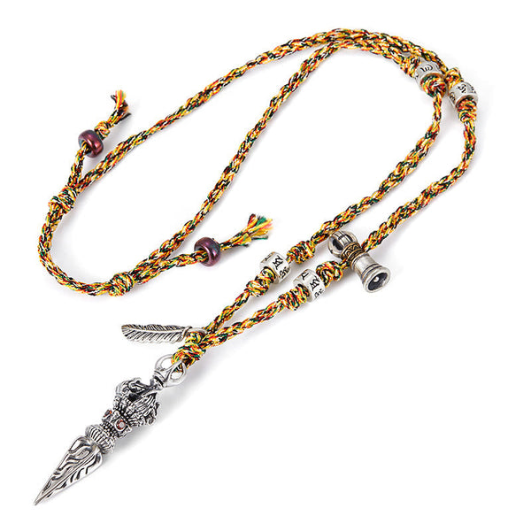 Dorje Vajra Pendant – Top-down flat lay showing braided cord with prayer wheel charm, mantra necklace