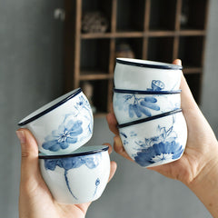 Koi Landscape Teacup – Close-up of koi swimming beneath lotus flowers, painted