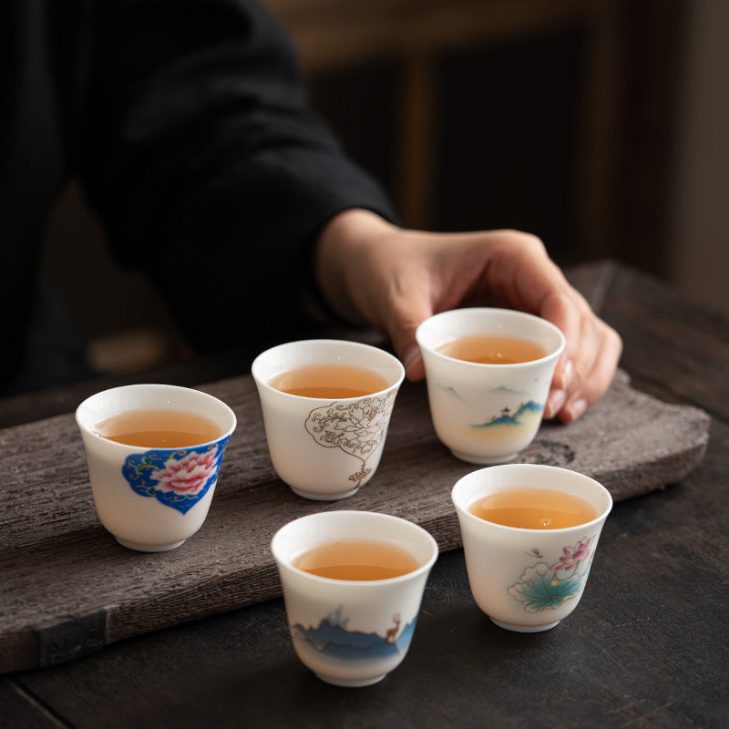 Ceramic Kung Fu Tea Cup – five-cup collection with lotus, peony, mountain and deer motifs on dark wood board, curated
