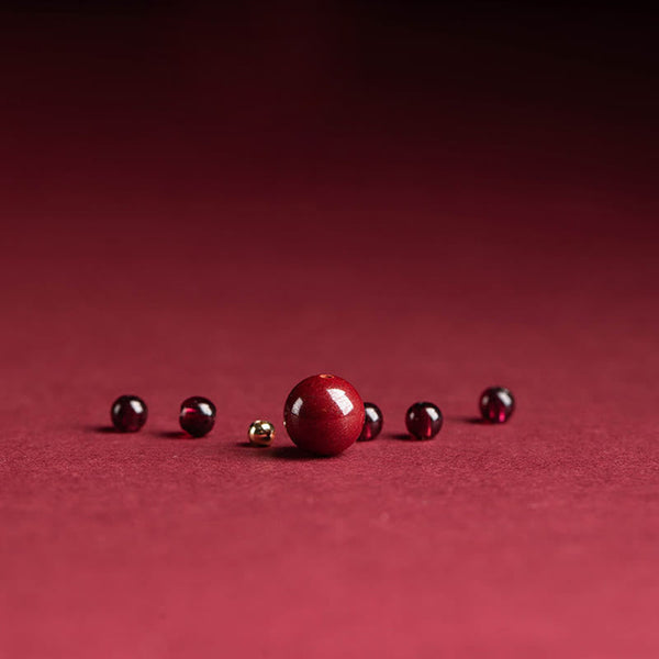 Garnet Cinnabar Ring – loose cinnabar garnet beads arrangement red background, raw material