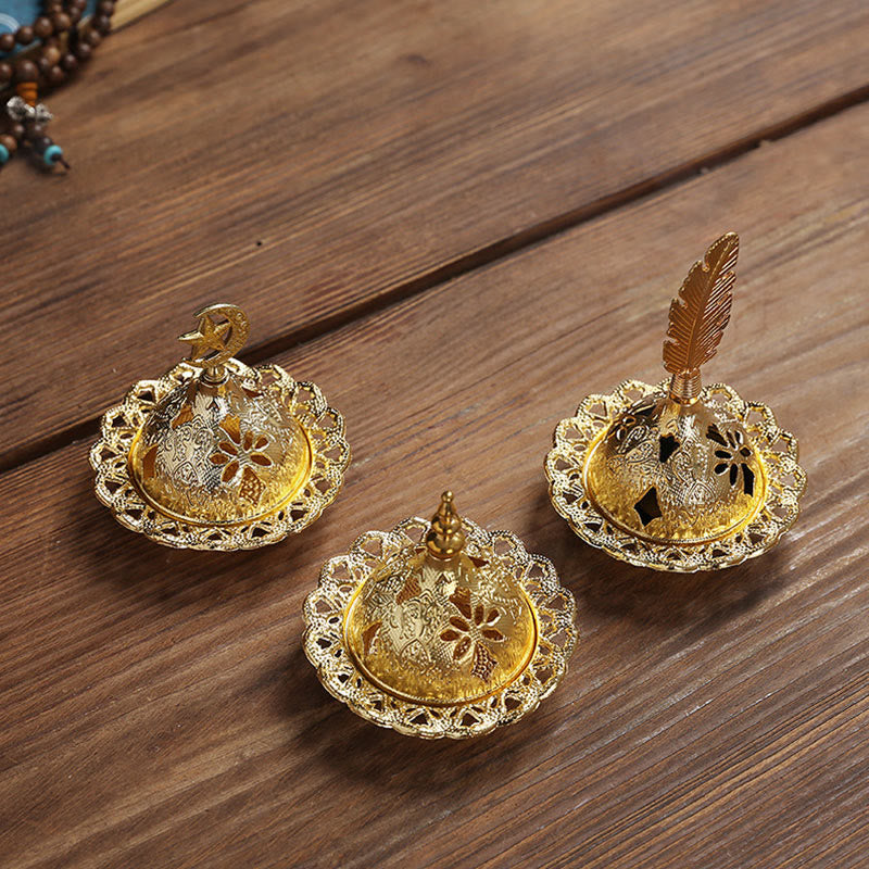 Mini Alloy Incense Burner – three gold dome lids with star, spire and feather finials on wood grain