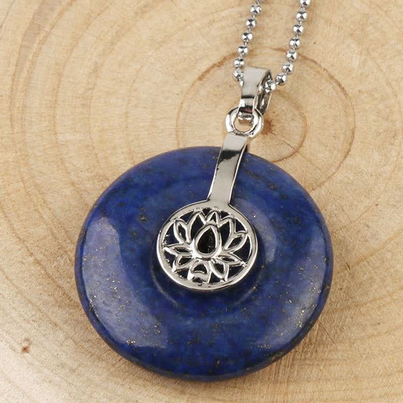 Crystal Amethyst Pink Crystal Lotus Necklace – Lapis lazuli lotus donut pendant with ball chain on wood, deep blue wisdom stone