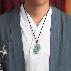Jade PiXiu Necklace – Man wearing green jade Pixiu pendant under grey robe, spiritual wealth necklace