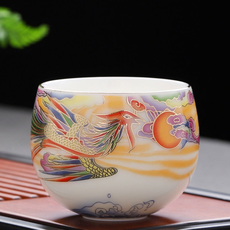 Dragon Phoenix Ceramic Teacup - Phoenix in flight with sun disk on black background, luxurious