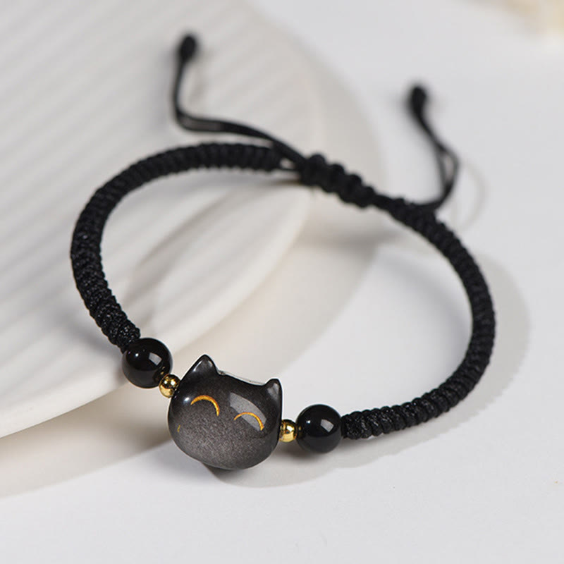 Black braided cord bracelet with gray obsidian cat charm, gold accent beads and adjustable sliding knot closure, minimalist feline jewelry