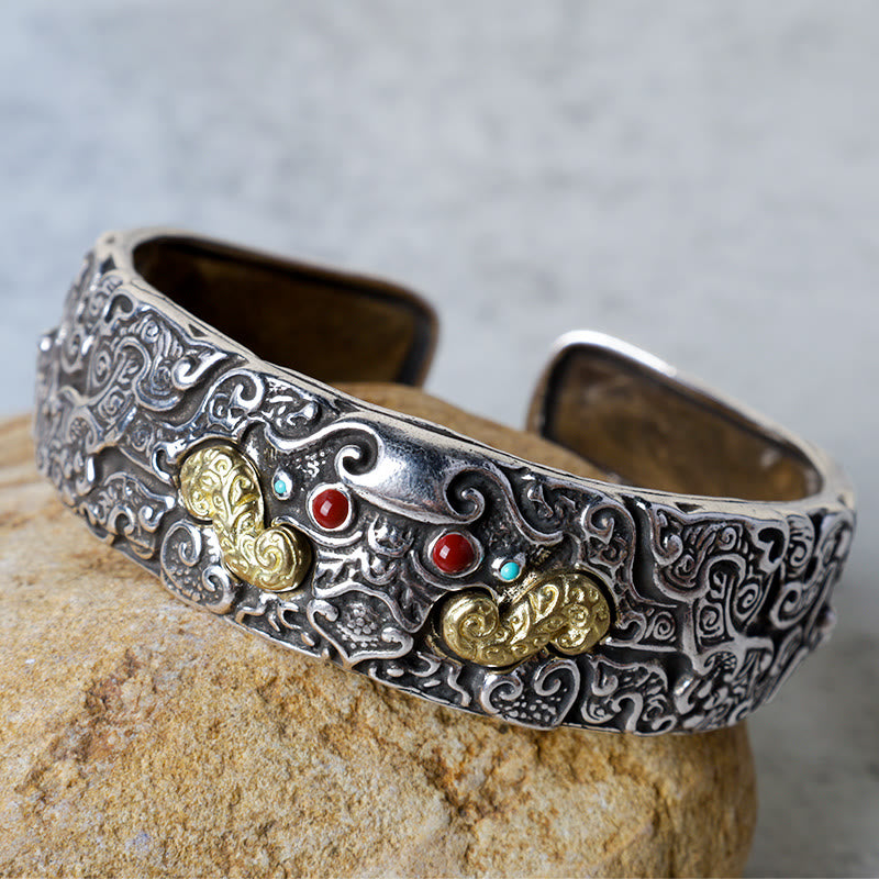 PiXiu Engraved Blessing Bracelet Bangle – detailed silver cuff with gold accents and red turquoise stones on rock Imagen principal del producto