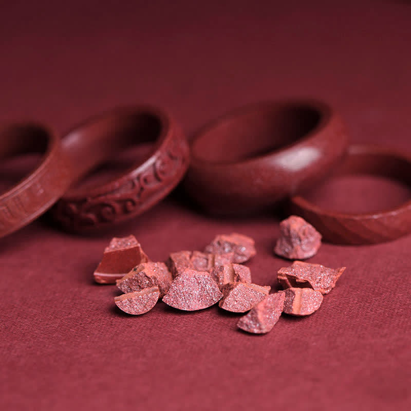 Cinnabar Om Mani Padme Hum Blessing Ring – broken cinnabar fragments revealing crystalline texture, bangles in background, authenticity shot