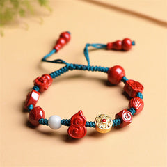 Cinnabar Laughing Buddha Bracelet – full view red gourd charm with Happy Buddha on black cord, wrist jewelry