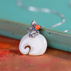 White Jade Elephant Lotus Necklace - Ruyi white jade pendant with silver lotus setting and red carnelian on ceramic
