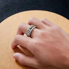 Feng Shui PiXiu Wealth Prayer Wheels Couple Ring – male hand wearing silver PiXiu ring on wooden table, adjustable unisex wealth band