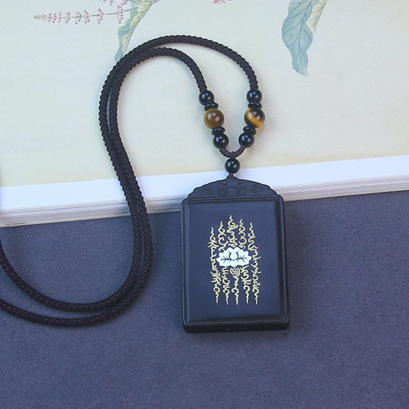 Ebony Wood Lotus Pendant – Side angle with tiger eye beads on cord, Grounding