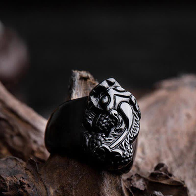 FengShui PiXiu Strength Ring – Glossy black obsidian pixiu ring on driftwood, strength amulet