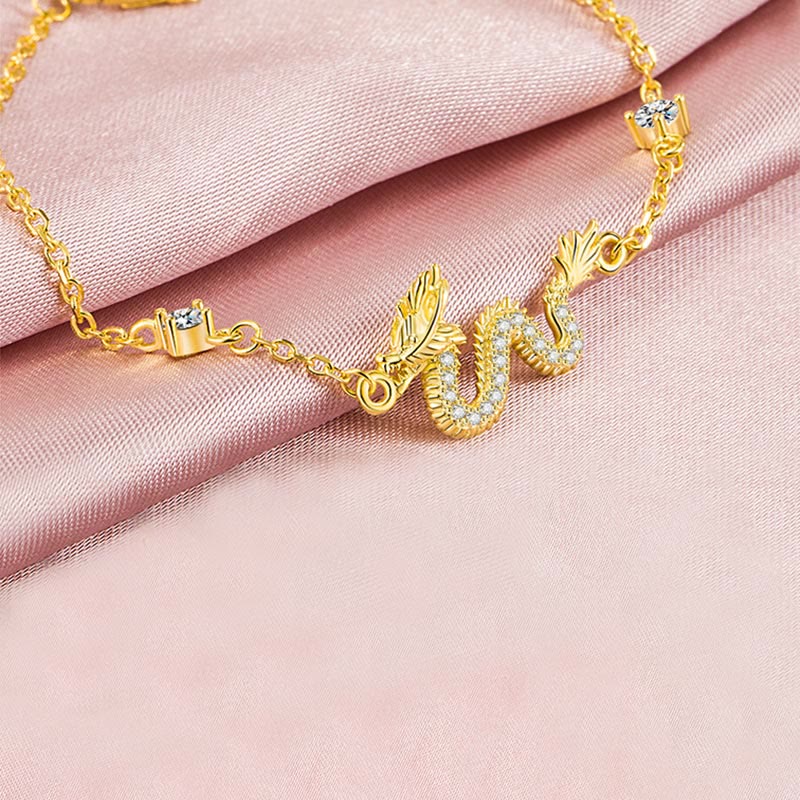 925 Silver Dragon Bracelet - Gold chain dragon with crown charm on pink fabric, fantasy jewelry