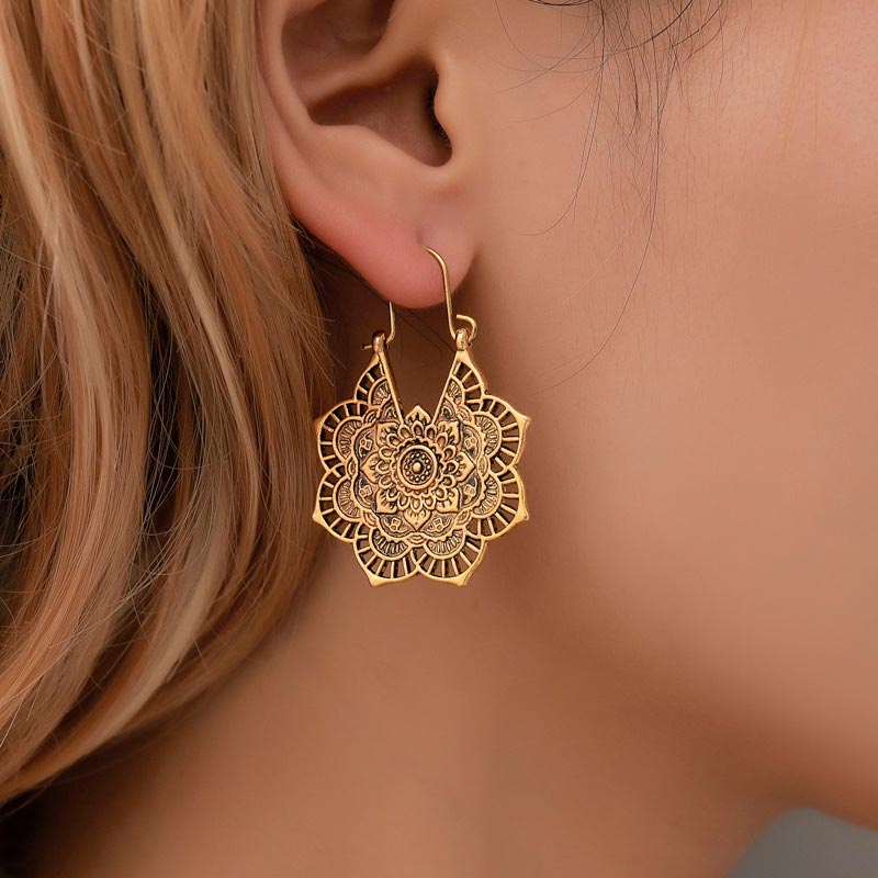 Tibetan Copper Lotus Engraving Drop Earrings – Ornate copper mandala dangle earring with eight-petaled lotus design and engraved details worn on model's ear