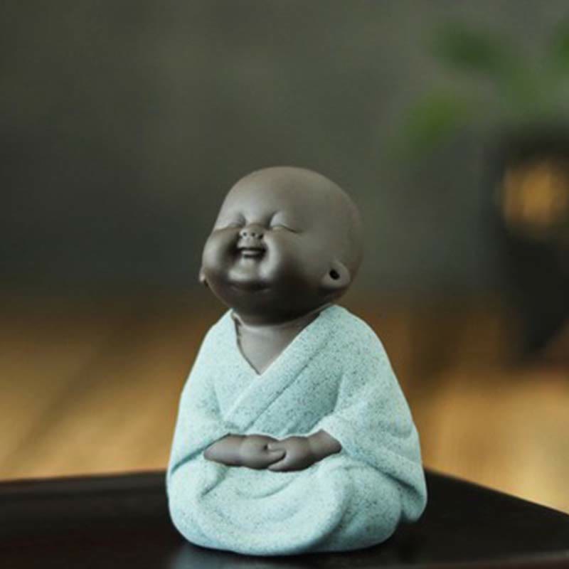 Laughing Buddha Purple Clay Maitreya Statue – two-tone clay Buddha with hands at sides, off-white textured robe and polished brown head, warm amber background