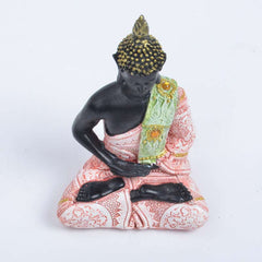 Tibetan Buddha Resin FengShui Decoration – angled view of black resin Buddha with ornate green-pink sash, white studio backdrop, Zen accent