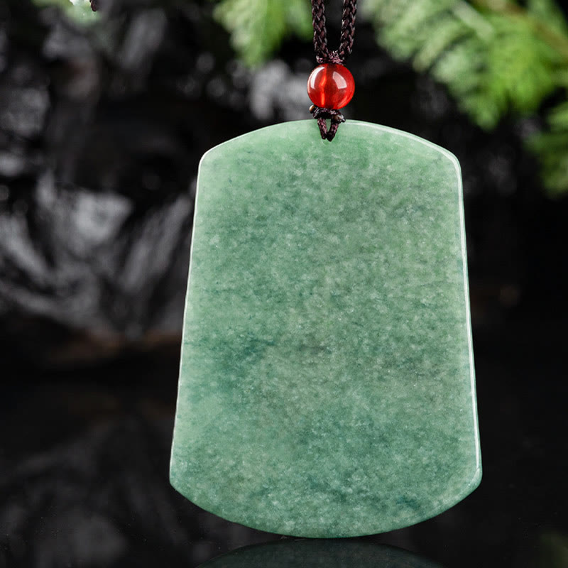 Natural Jade Dragon Pendant – Polished green jade peace plaque with red bead on dark background, Pure serenity