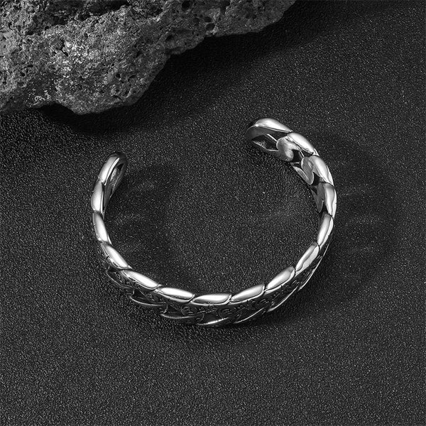 Tibetan Om Mani Padme Hum Cuff Bangle – dramatic lighting on black sand, twisted chain link detail, open cuff design