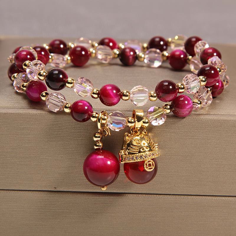 Tiger Eye Pixiu Fox Money Bag Bracelet - double-strand burgundy tiger eye crystal bracelet with gold lucky cat maneki-neko charm and money bag wealth sphere, feng shui prosperity jewelry on wooden surface
