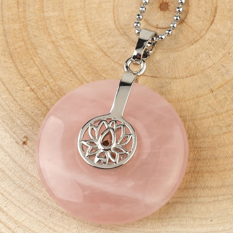 Crystal Amethyst Pink Crystal Lotus Necklace – Rose quartz lotus donut pendant with ball chain on wooden surface, love stone healing