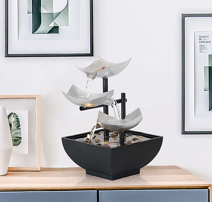 Three Layers Lotus Waterfall Fountain - Silver tiers on wood table with framed art, Zen