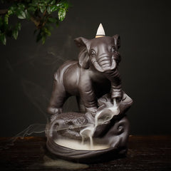 Purple Clay Elephant Incense Burner – Front-left angle, white smoke through trunk into lotus pool, zen meditation decor