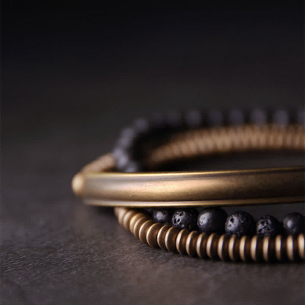 Lava Rock Copper Healing Bracelet – Black porous lava bead bracelet with copper center bead and silver spacers worn on wrist, soft blurred neutral background lifestyle