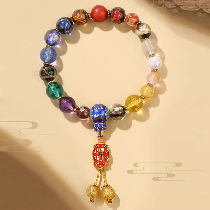 Tibetan Liuli Wrist Mala – Translucent glass beads in rainbow gradient with golden cloisonne center