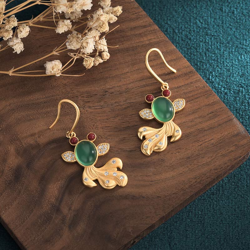 Feng Shui Koi Dangles - paired earrings on display showing symmetrical koi design, jade