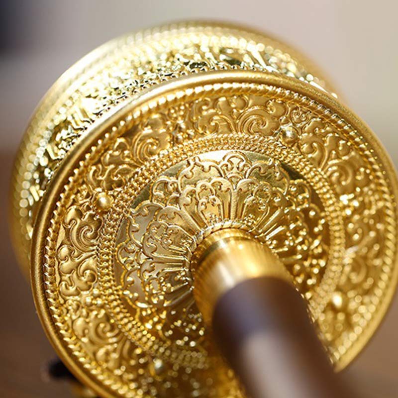 Sandalwood Tibetan Prayer Wheel – Macro close-up of eight-petaled lotus medallion on golden end cap, intricate Buddhist me...