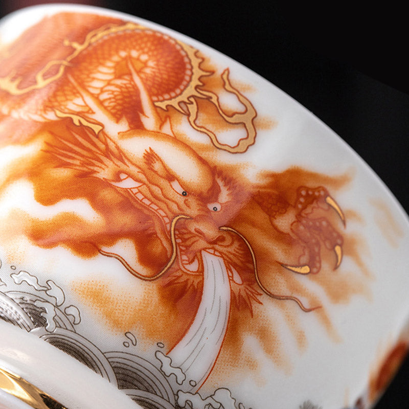 Dragon Phoenix Crane Gilt Ceramic Teacup – signed artisan base with gold foot rim, iron red and cobalt blue landscape, handcrafted