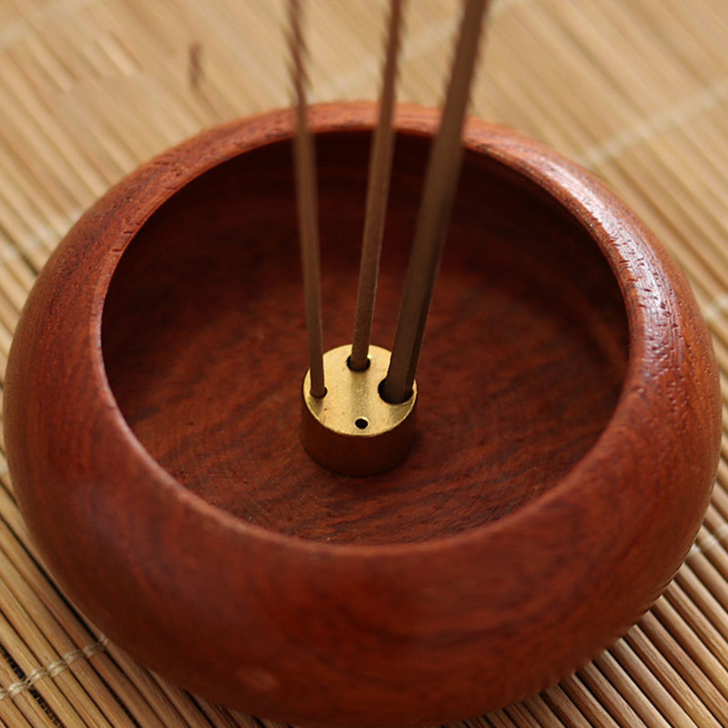 Rosewood Incense Burner – three incense sticks standing in brass fitting, smoke wisps above rich grain, meditative