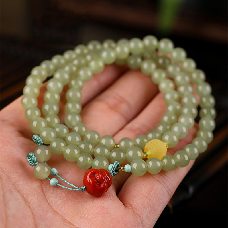 Red Agate Laughing Buddha Bracelet - Side angle showing bead craftsmanship, spiritual lucky accessory