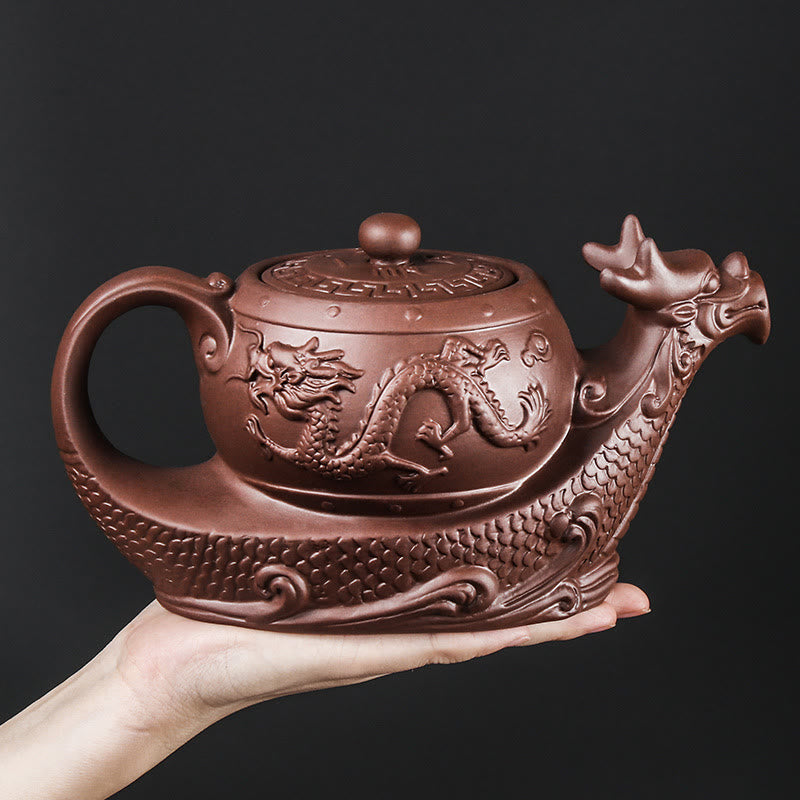 Vintage Dragon Auspicious Clouds Teapot – hand-held terracotta dragon teapot on black background, size reference visible