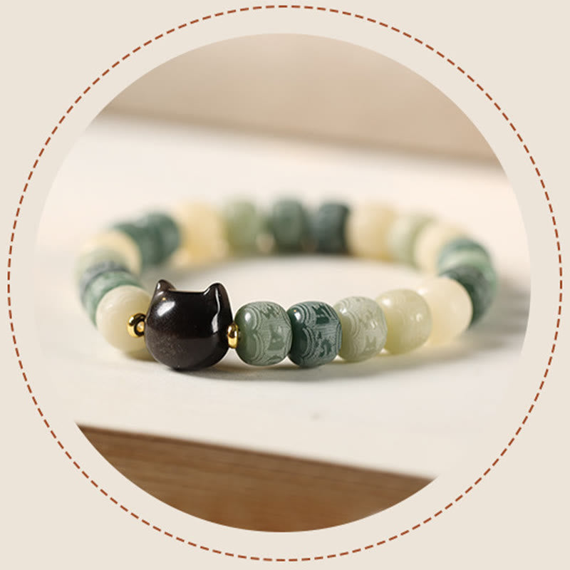 Bodhi Seed Cat Head Bracelet – Curved view of green marbled beads with dark cat head charm in shallow focus, artisan spiritual jewelry
