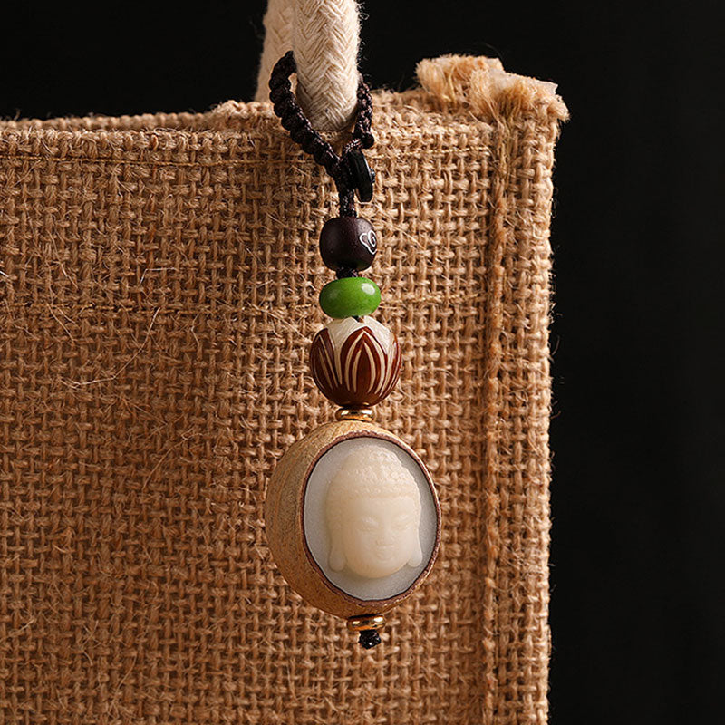 Bodhi Seed Blessing Keychain - full pendant hanging from thick hemp rope against dark burlap showing all bead details, mindfulness