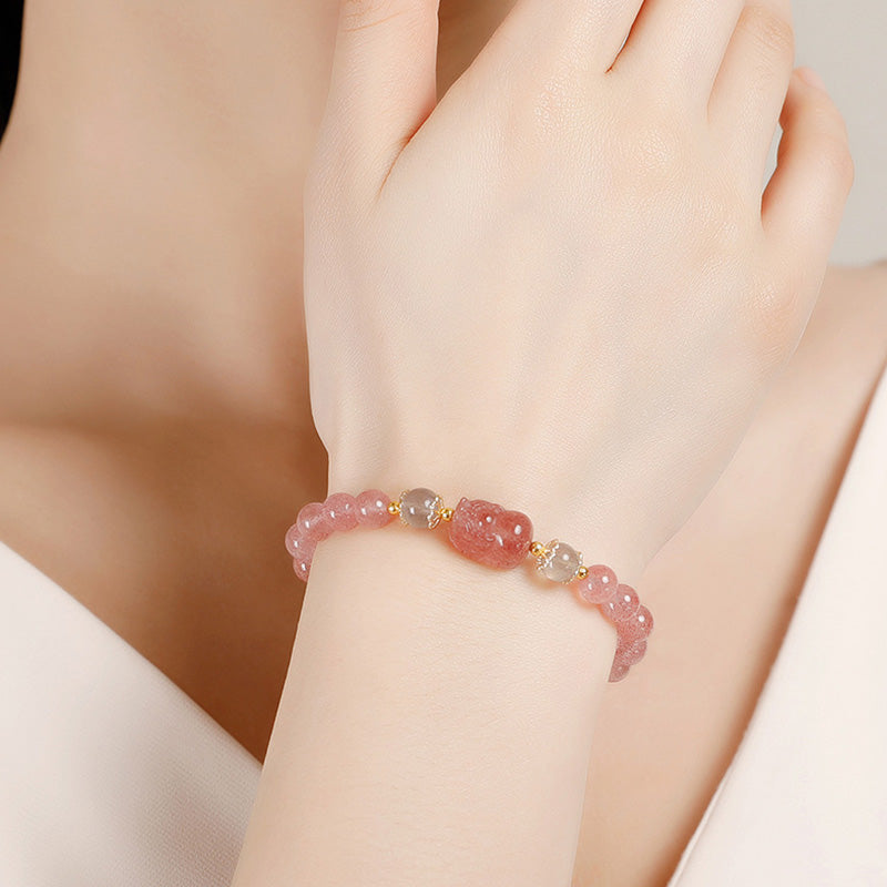 Strawberry Quartz PiXiu Bracelet – model wearing pink bracelet PiXiu centerpiece, good luck charm