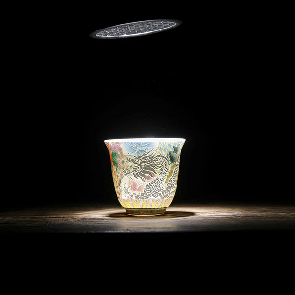 Dragon Phoenix Ceramic Teacup - Backlit cup glowing with translucent dragon on dark wood, Dramatic elegance