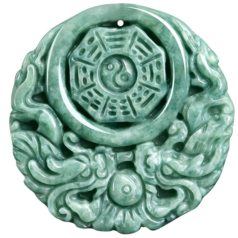 Dragon Jade Yin Yang Necklace – Mottled green jadeite disc pendant with dragon Bagua yin-yang relief carving on dark cord, dark reflective surface three-quarter low angle